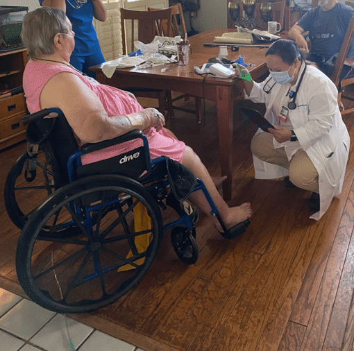 Patient receives hospital care at home, surrounded by family and field nurses and directed by a physician