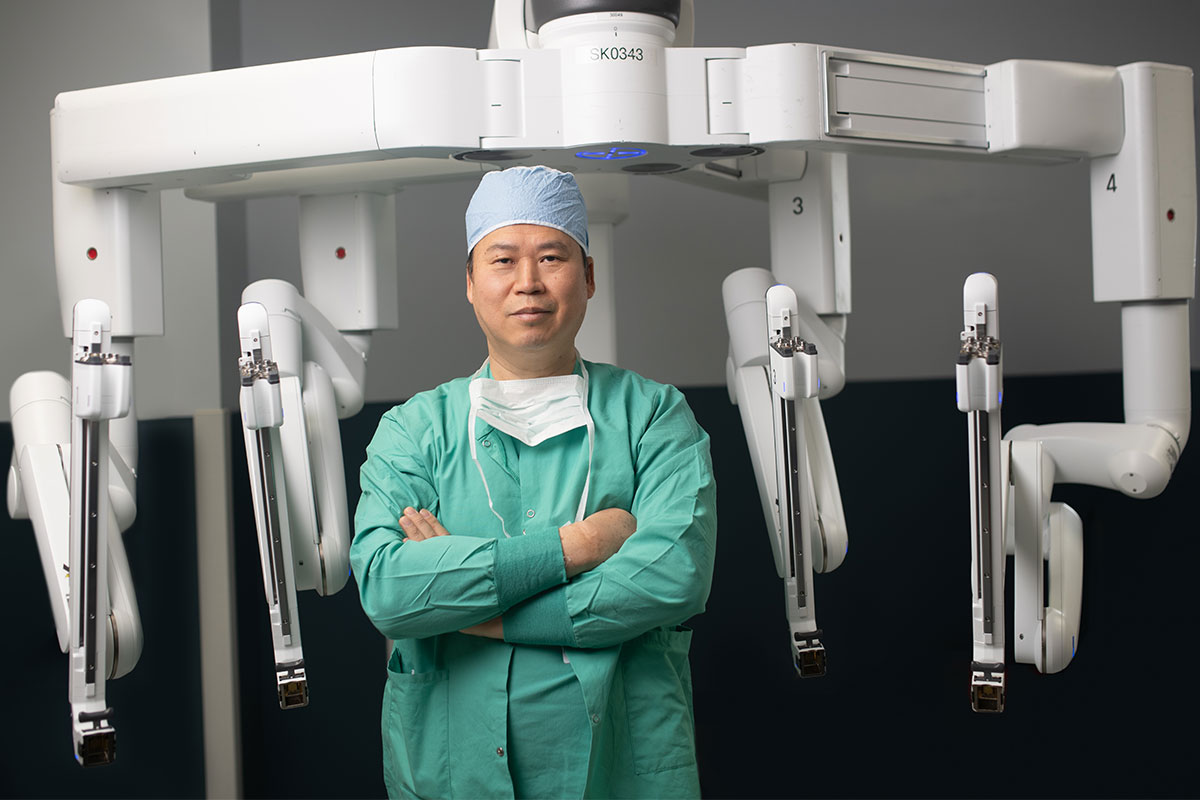 ahlm-john-lee-posing-in-front-of-equipment.jpg